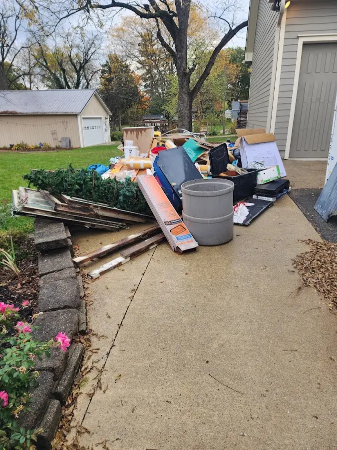 Dumpster being loaded with debris for Estate Cleanout Dumpster Rental in Milaca